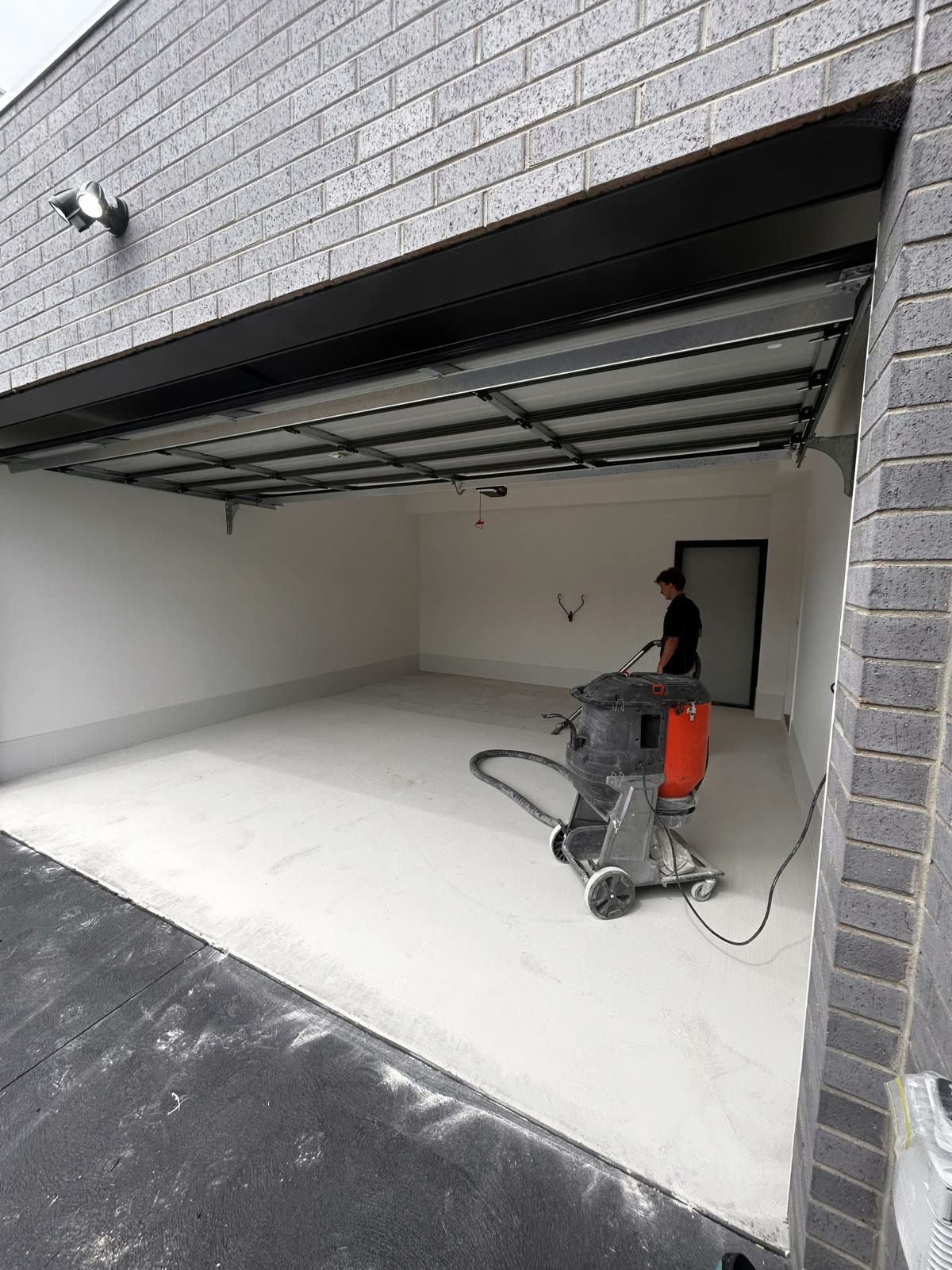 Diamond grinding and preparing a garage concrete floor before coating